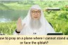 How to pray on a plane where I cannot stand up or face the qiblah?