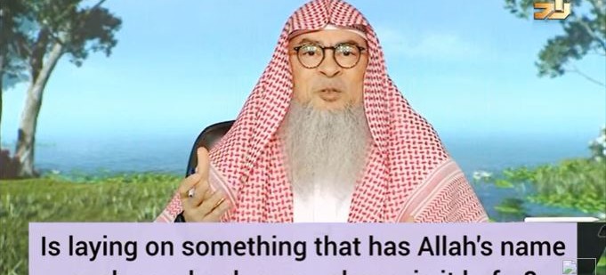 Laying on something that has Allah's name such as a book or my phone, is it kufr?